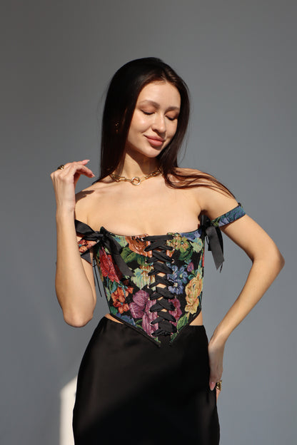 black floral corset top overbust, lace up corset front and back, tapestry corset with black flowers pattern, structured corset top for waist shaping, gothic romantic corset outfit, adjustable lace up corset top, custom size corset for perfect fit, elegant black corset with floral fabric texture, feminine silhouette shaping corset, ditogs corsets black flowers design
