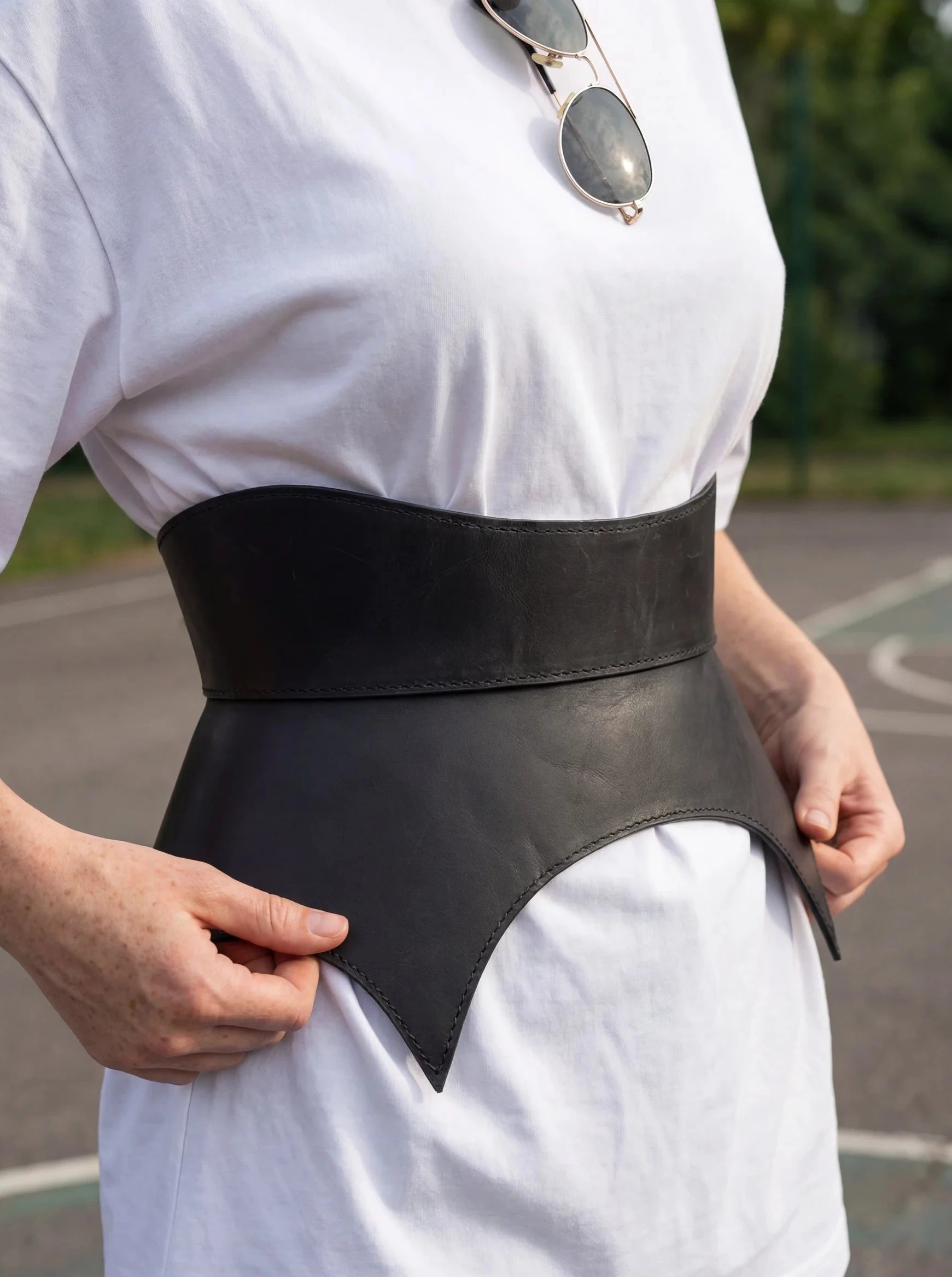 black leather basque belt cutout peplum waist belt structured waist belt sculpted leather belt statement outfit styling modern fashion waist belt
