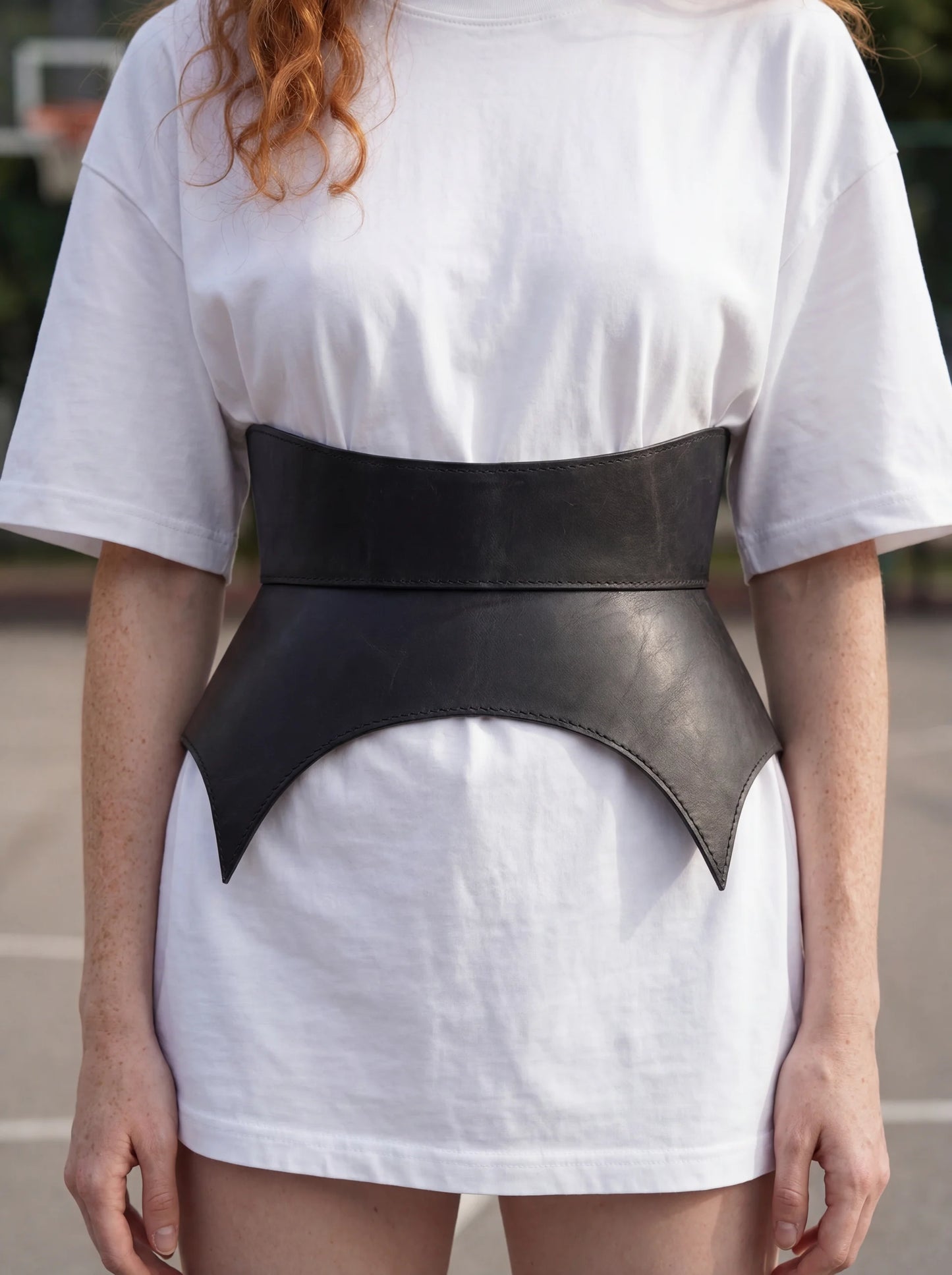 black leather basque belt cutout peplum waist belt structured waist belt sculpted leather belt statement outfit styling modern fashion waist belt