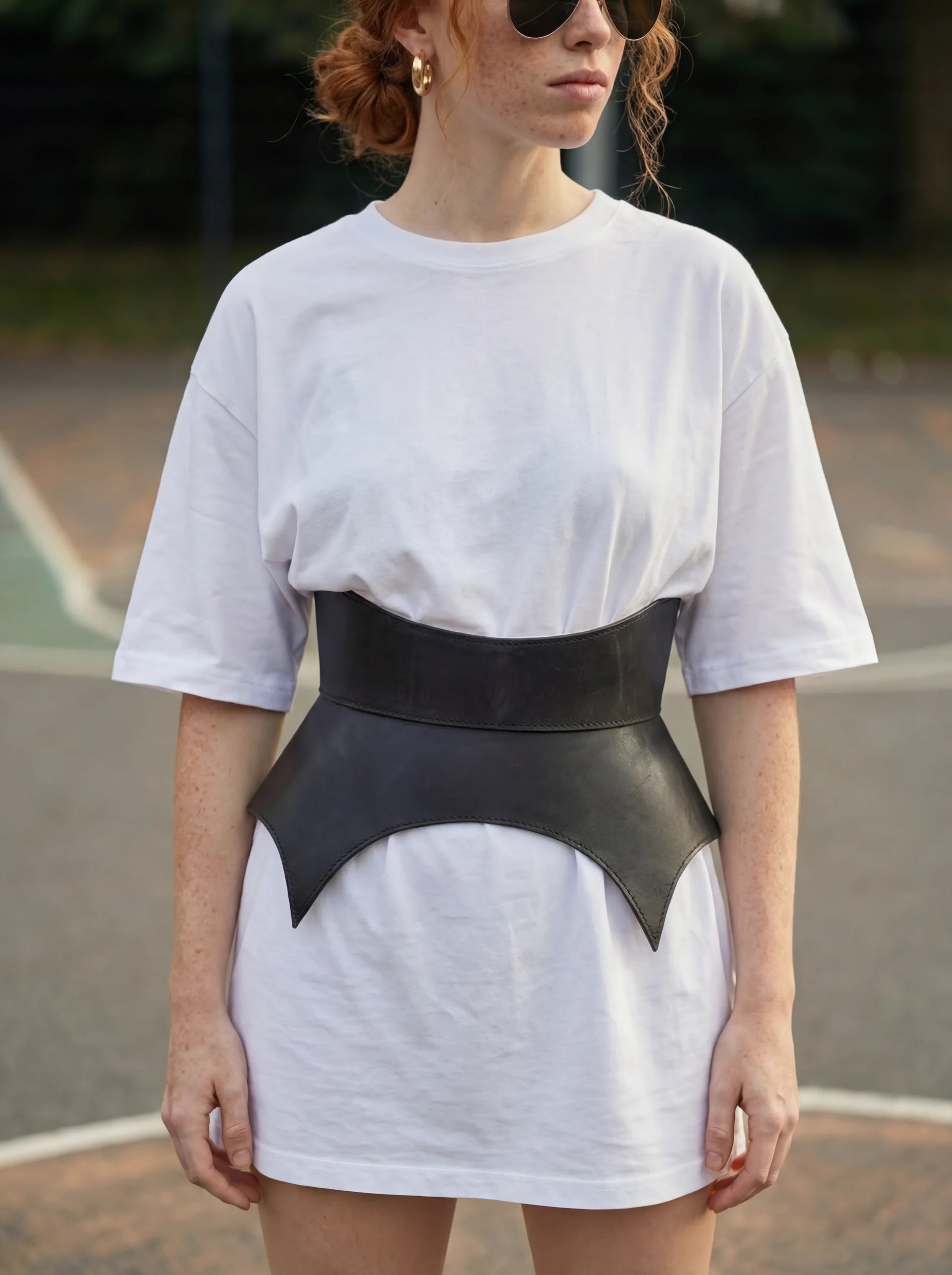 black leather basque belt cutout peplum waist belt structured waist belt sculpted leather belt statement outfit styling modern fashion waist belt