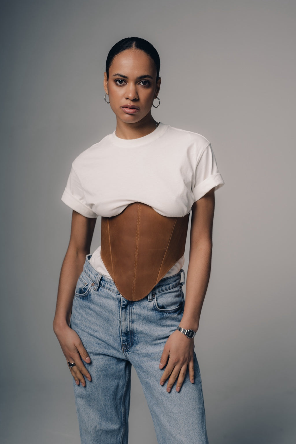 Beige long leather underbust corset belt styled with jeans