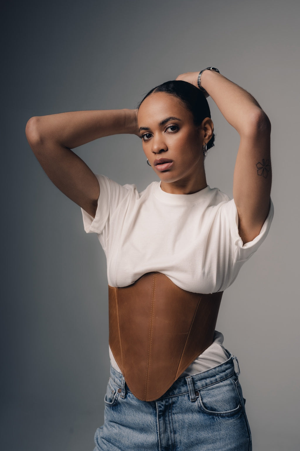 Portrait styling with beige long leather underbust corset belt