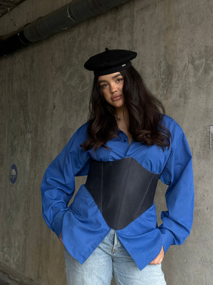 Blue long leather underbust corset belt styled with blue shirt