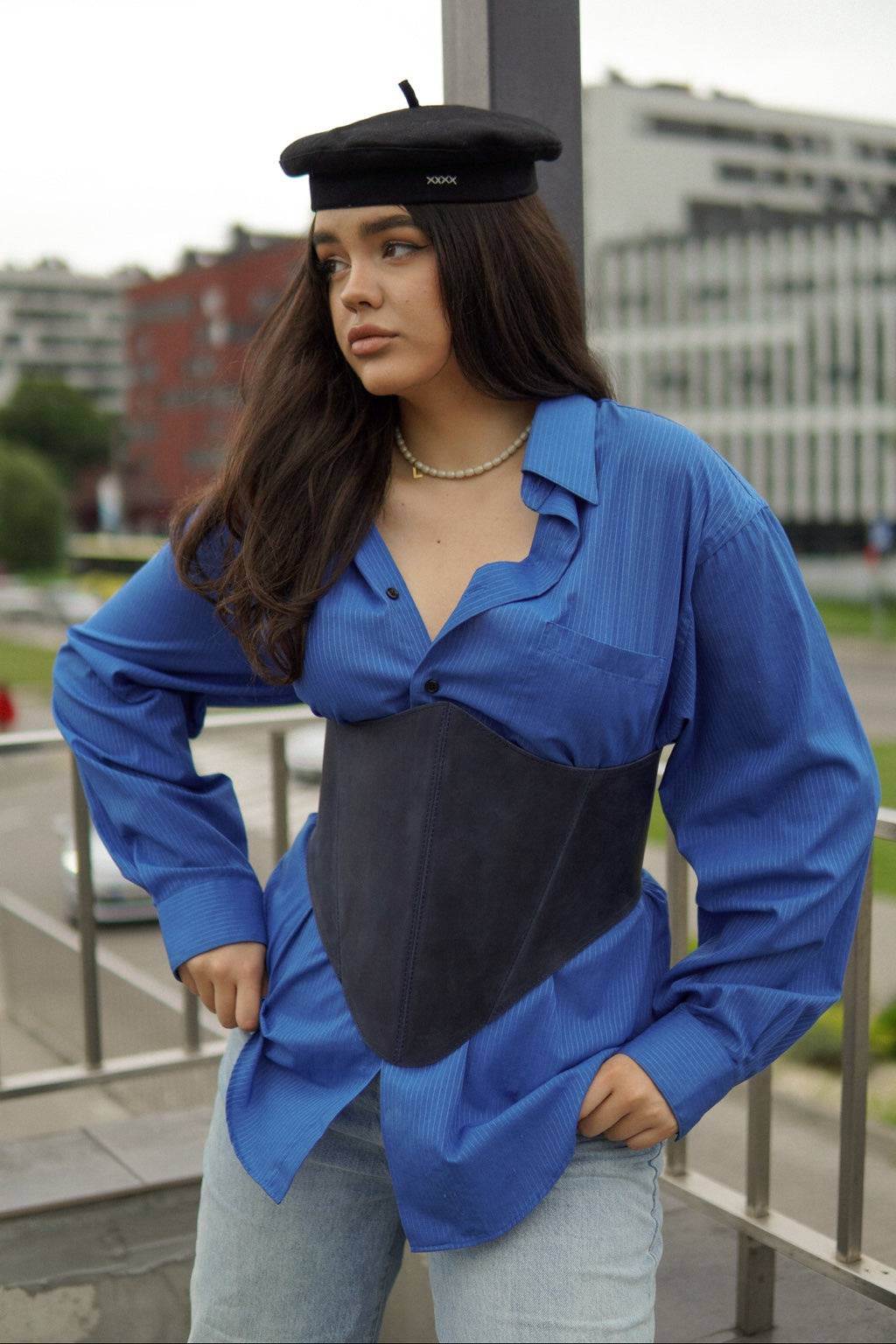 Portrait styling with blue long leather underbust corset belt
