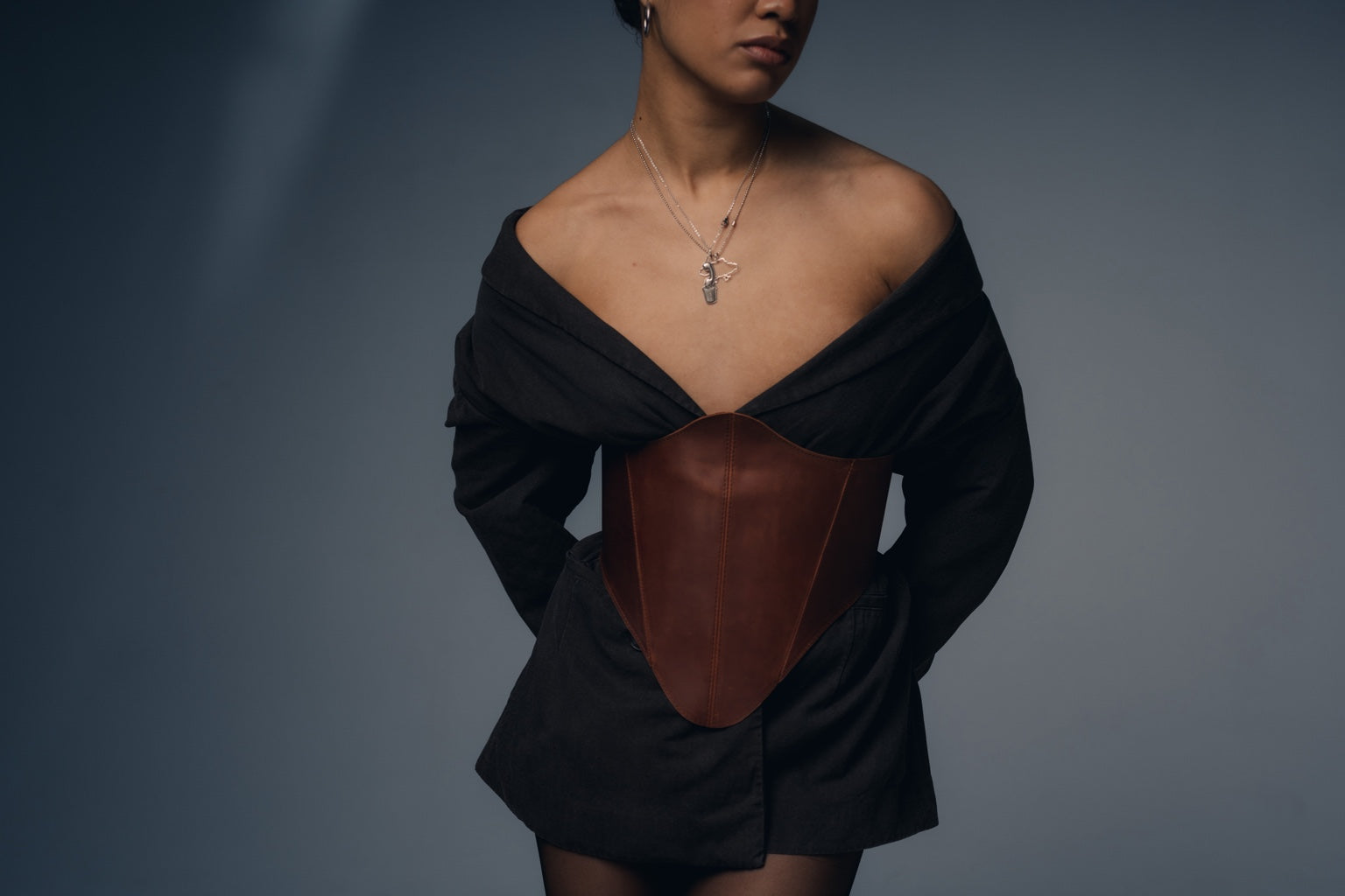 Cognac long leather underbust corset belt seated chair pose