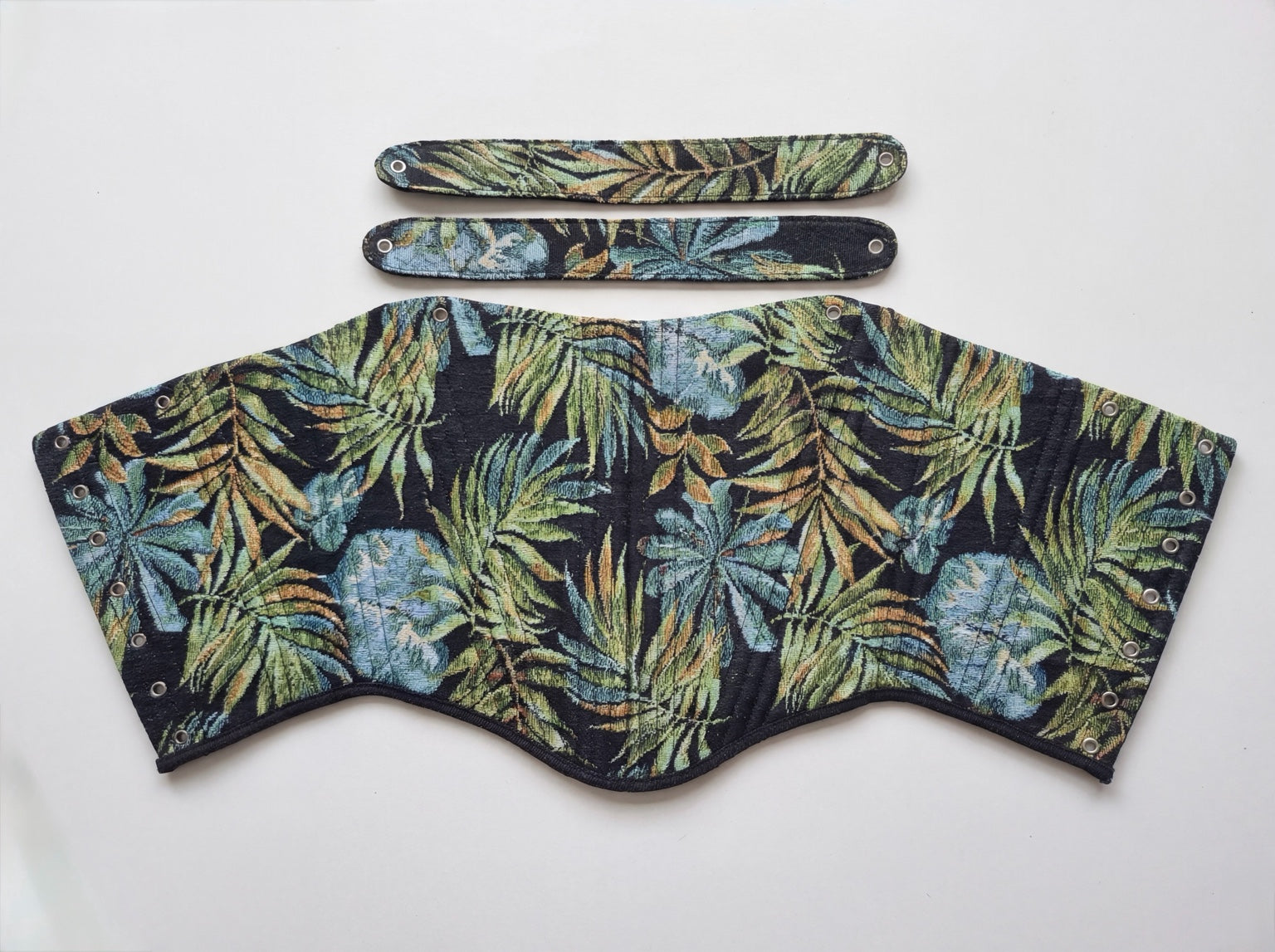 Dark tropical jacquard reversible corset top with black ribbon ties on white background